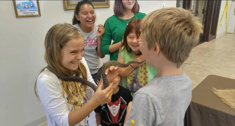 kids holding a snake
